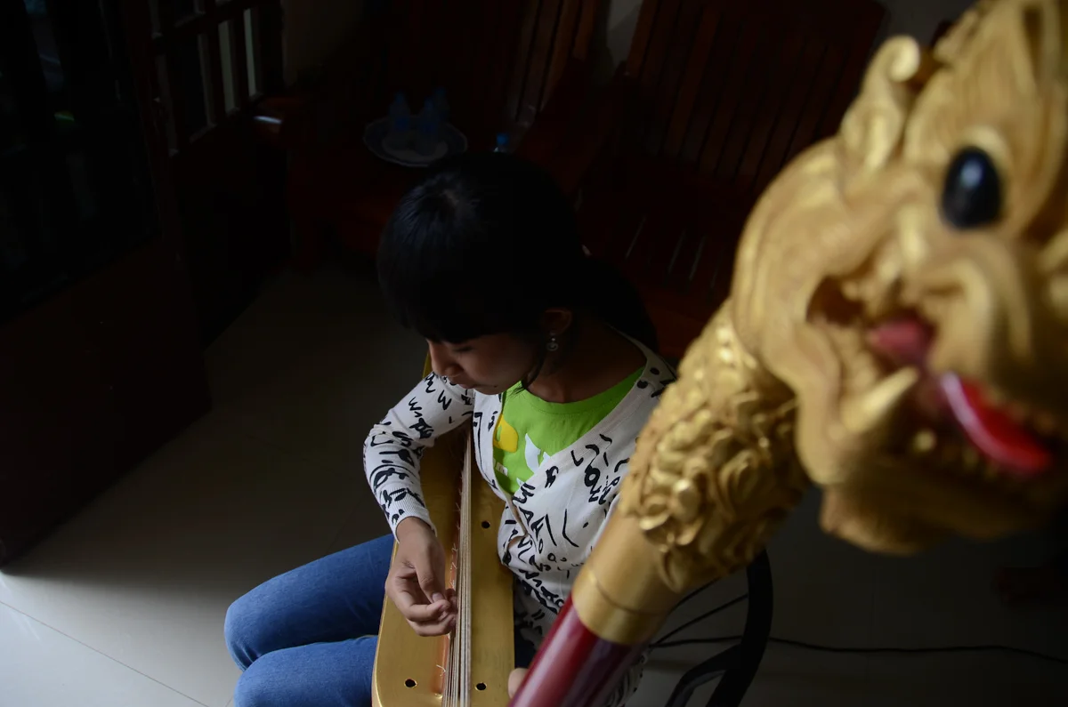 Snguon Kavei Sereyroth plays the harp at her home in Phnom Penh.