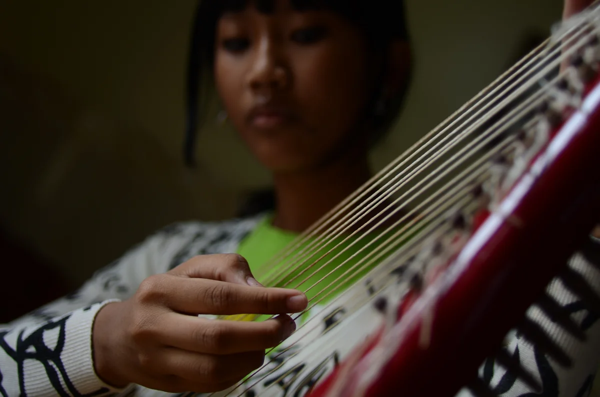 Snguon Kavei Sereyroth plays the harp at her home in Phnom Penh.