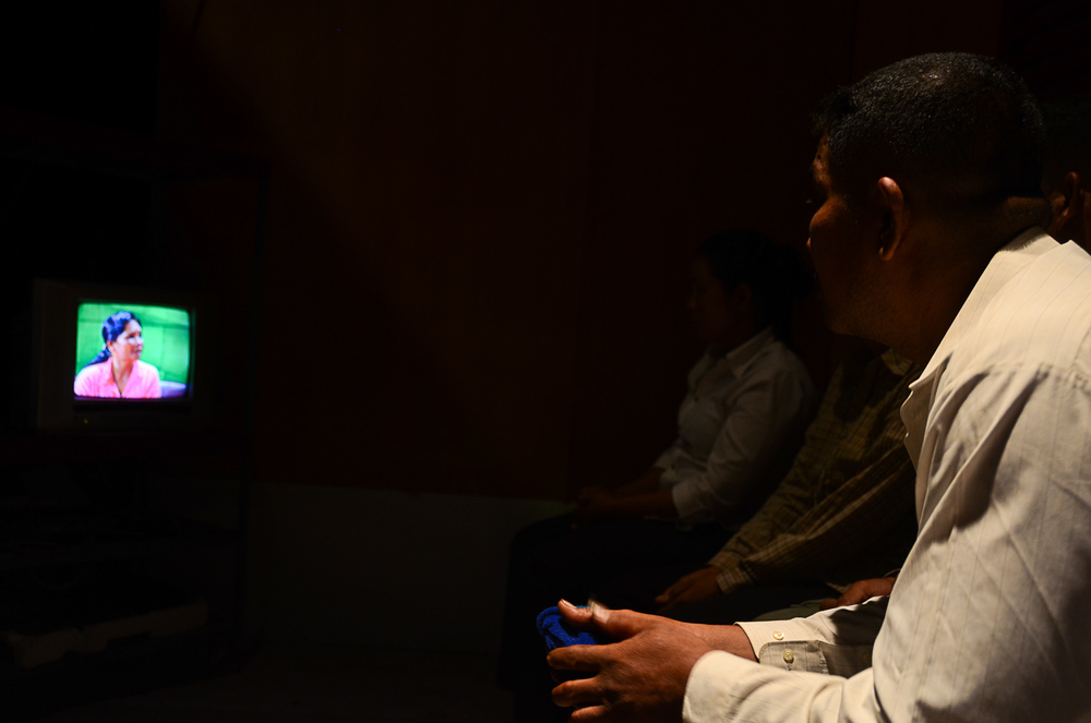  Khoem Sarom watches the show on a television screen backstage. He has not seen his niece since 1979. 