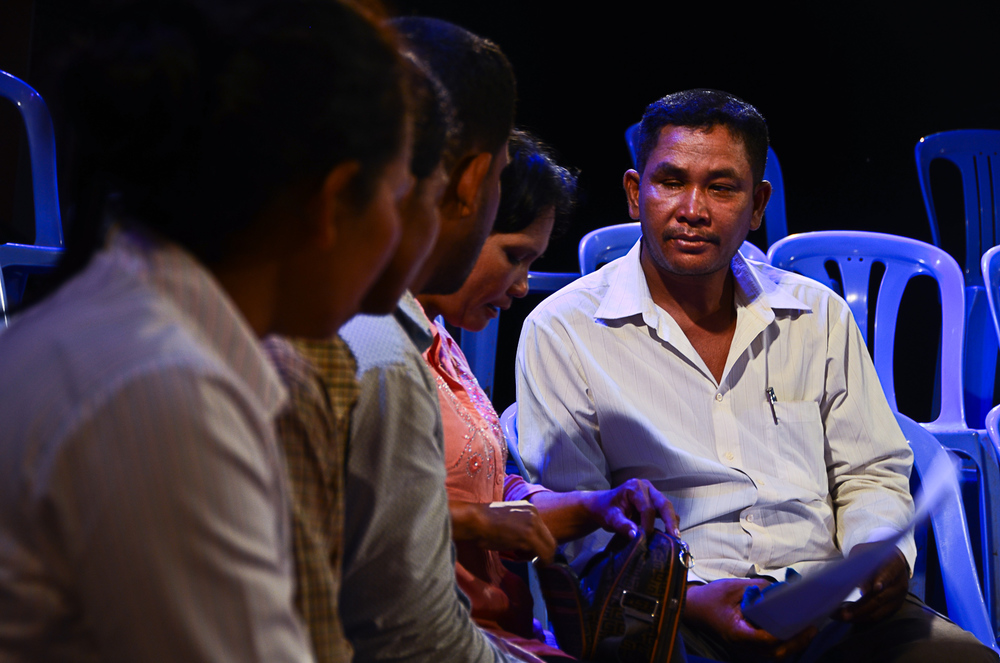  With the cameras off, Khoem Sarom, right, makes plans to get reacquainted with his niece, sitting to his right. It is the first time the pair have seen each other in almost 35 years. 