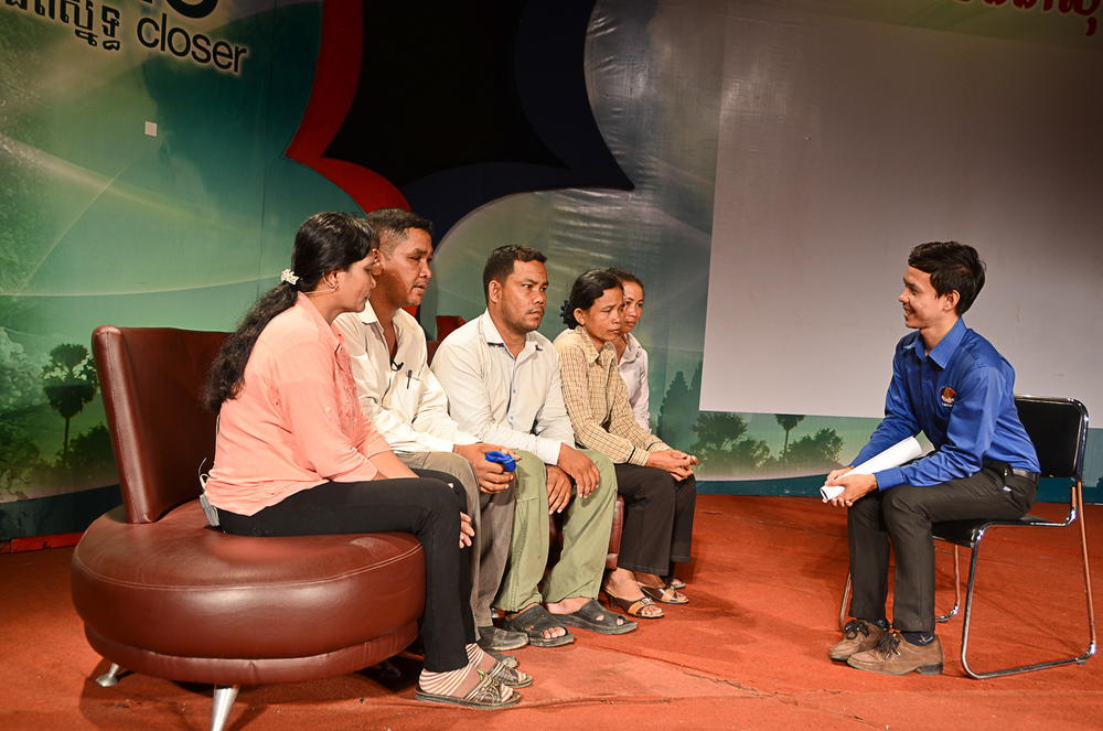  Seak Mala, left, sits beside his uncle and his immediate family after being re-united on stage. 