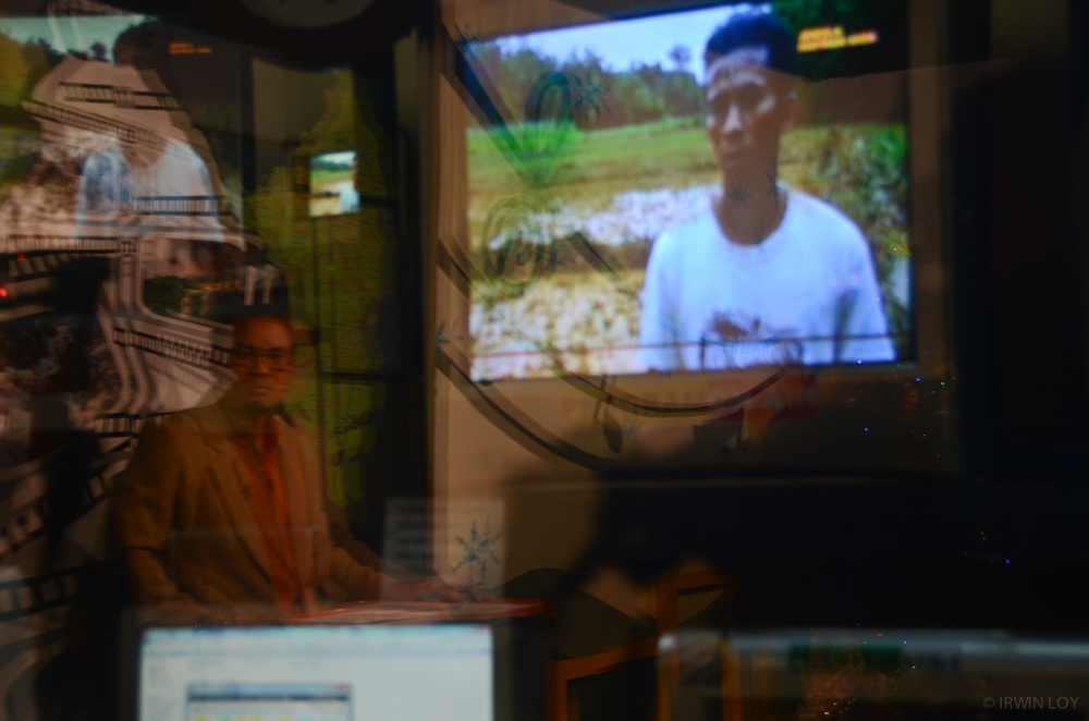  Alim, a journalist at RuaiTV, watches the screen as a pre-recorded TV package plays during the evening newscast, which he hosts. 