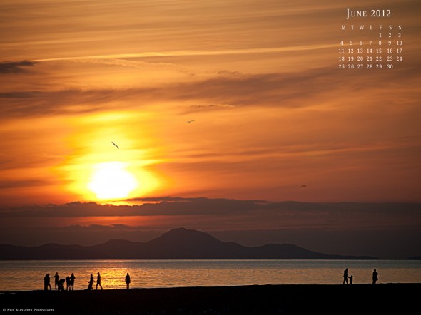 Kids playing in the setting sun on the beach at Barmouth - Desktop Wallpaper for June 2012