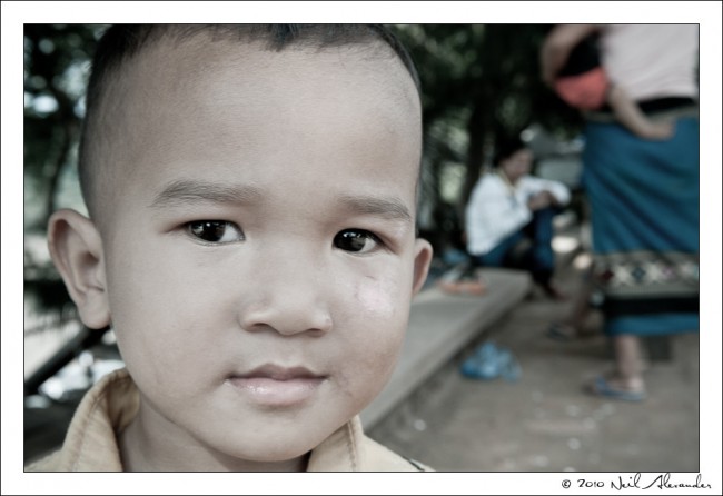 L aotion child on the street in Luang Prabang by Neil Alexander