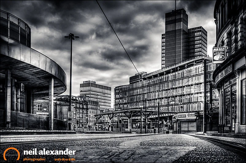 Looking down High Street, Manchester towards Shudehill bus and Metrolink station with the CIS Tower in the background