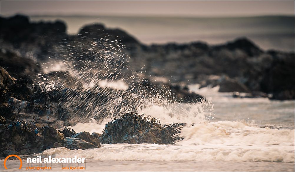 Waves crashing on the Rhosneigr beach, Anglesey, Wales, UK. Camera settings: F2.8, 1/50 sec, ISO 200. 200mm