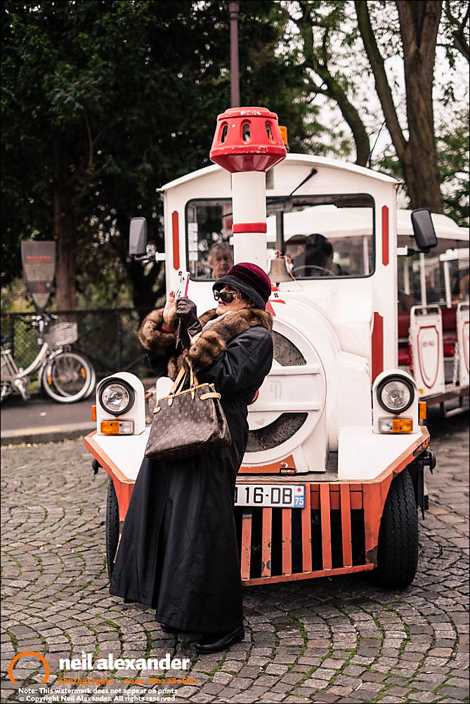 A woman taking a photograph near Sacr�-Coeur, Paris