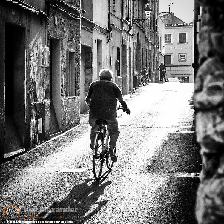 Man on a bicycle in the delightful Mallorcan town of Puerto Pollença