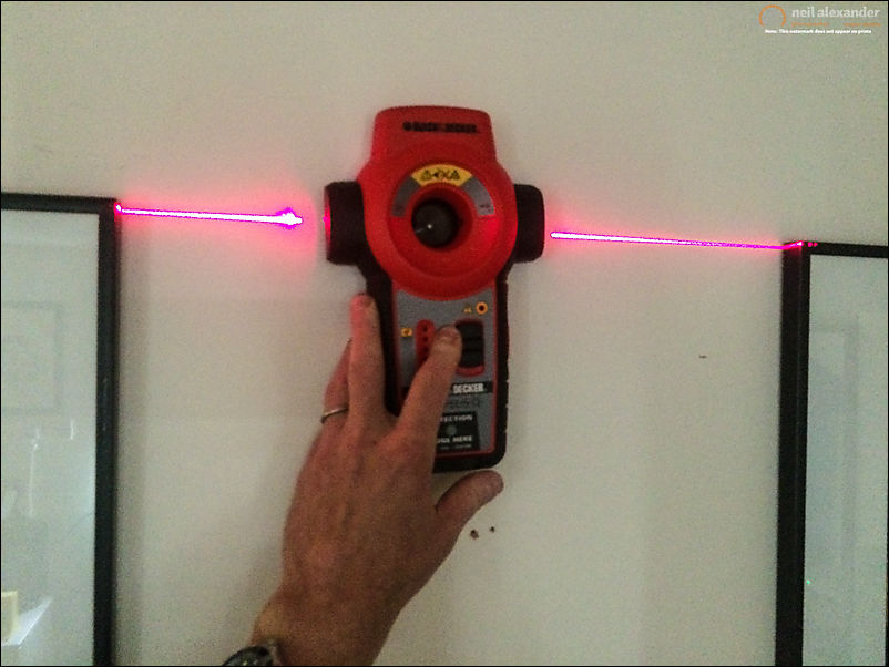 Using a laser level to make sure frames are lined up and aren't wonky.