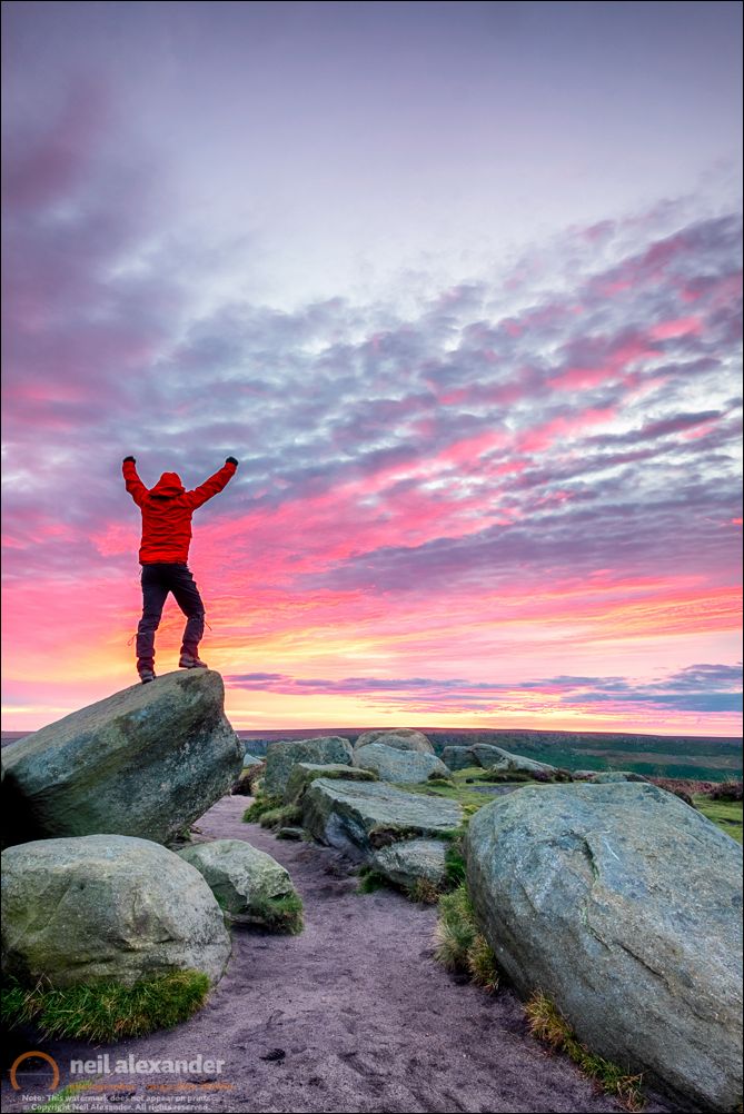 A lone hiker (yours truly) at sunrise over Higger Tor in the Peak District