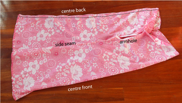 Make back of dress narrower by sewing in a new seam in the middle of the back.