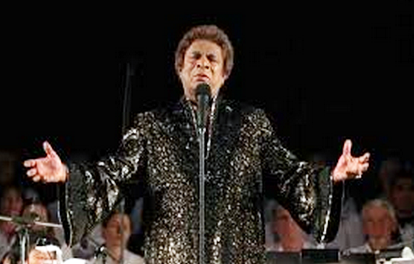 Kamahl, simultaneously resplendent and terrifying in a black and gold lame caftan