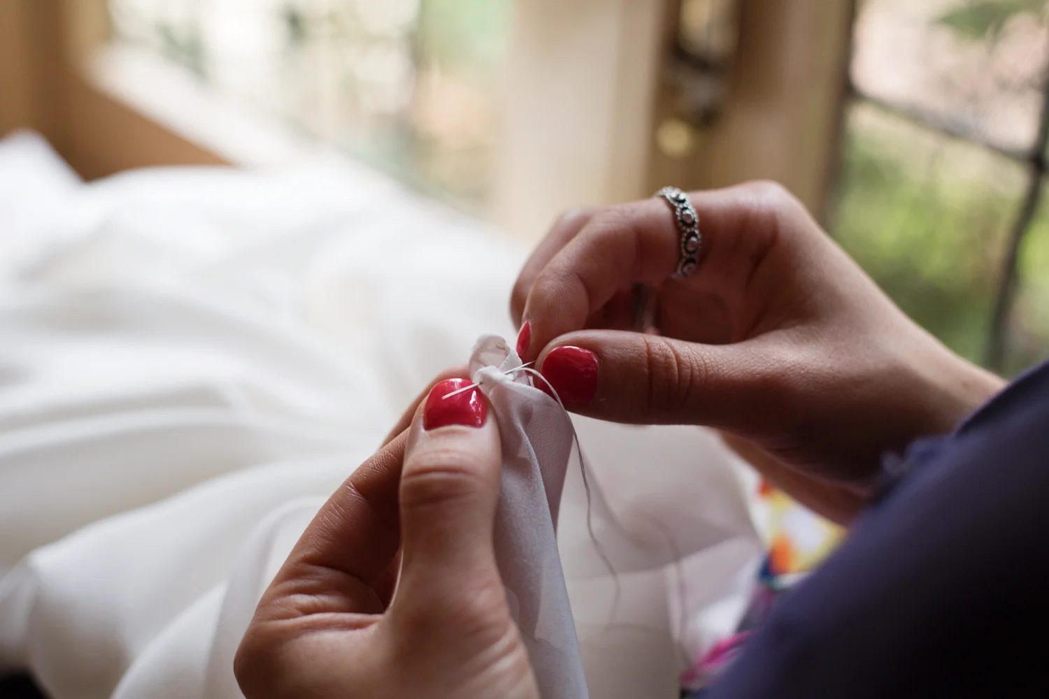 Roughly stitch all long the hem in white thread to keep the fabric in place when you remove the pins