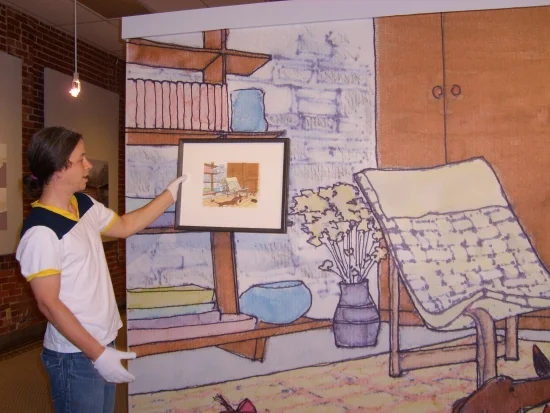 Here Ben Edwards of Crystal Bridges shows that colors print well on the material as he holds the original watercolor next to our Photo Tex installation.