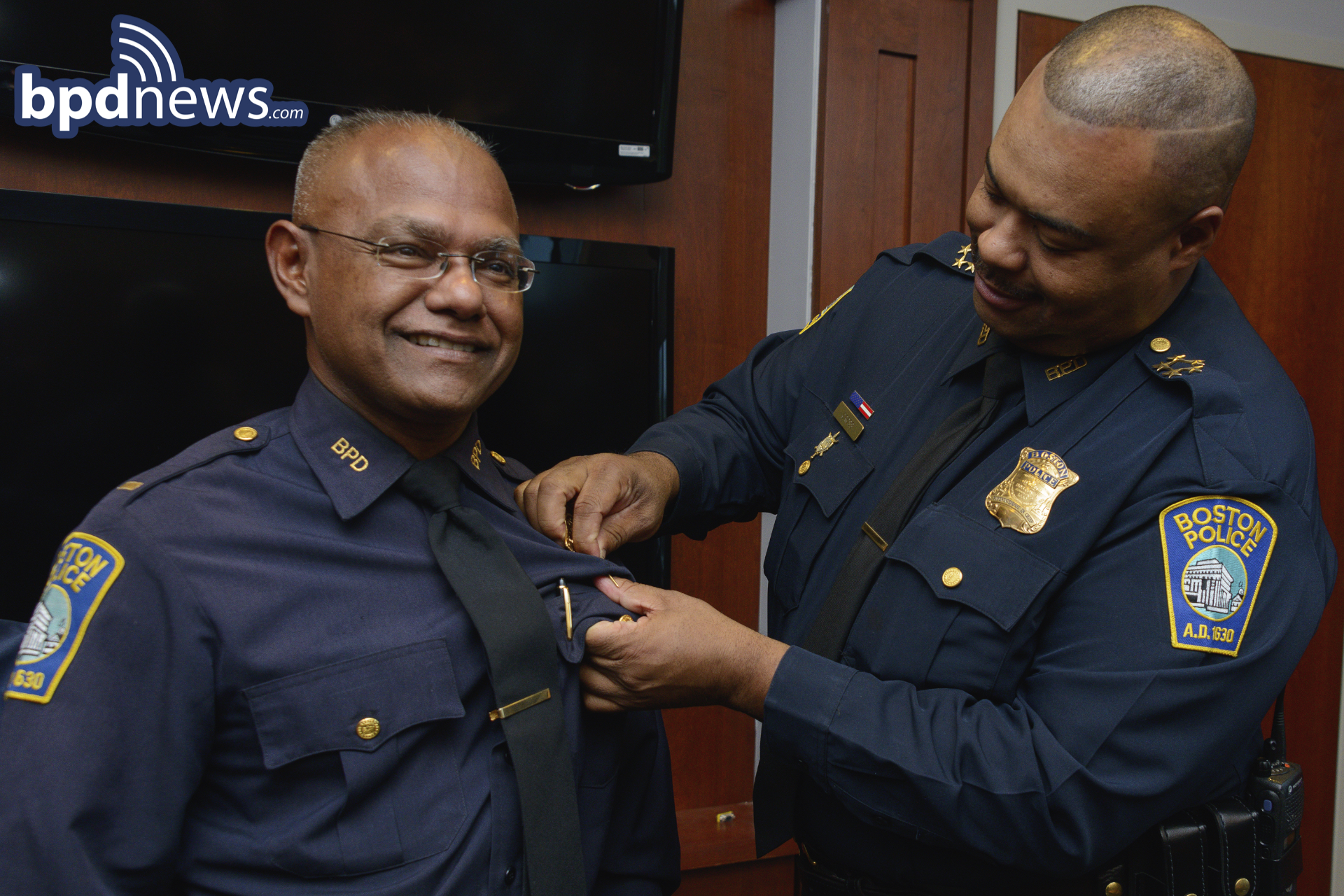 Captain Hosein receives his Captain's BAdge from Chief Gross