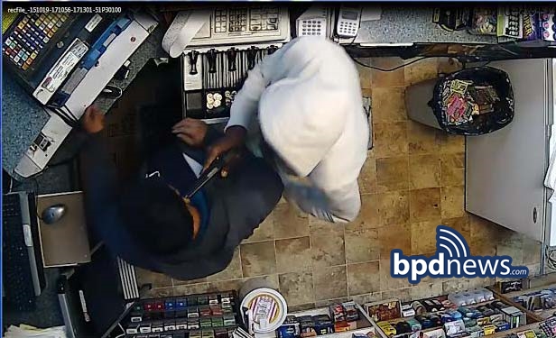 Surveillance photo showing a suspect using a replica firearm during the commission of an armed robbery