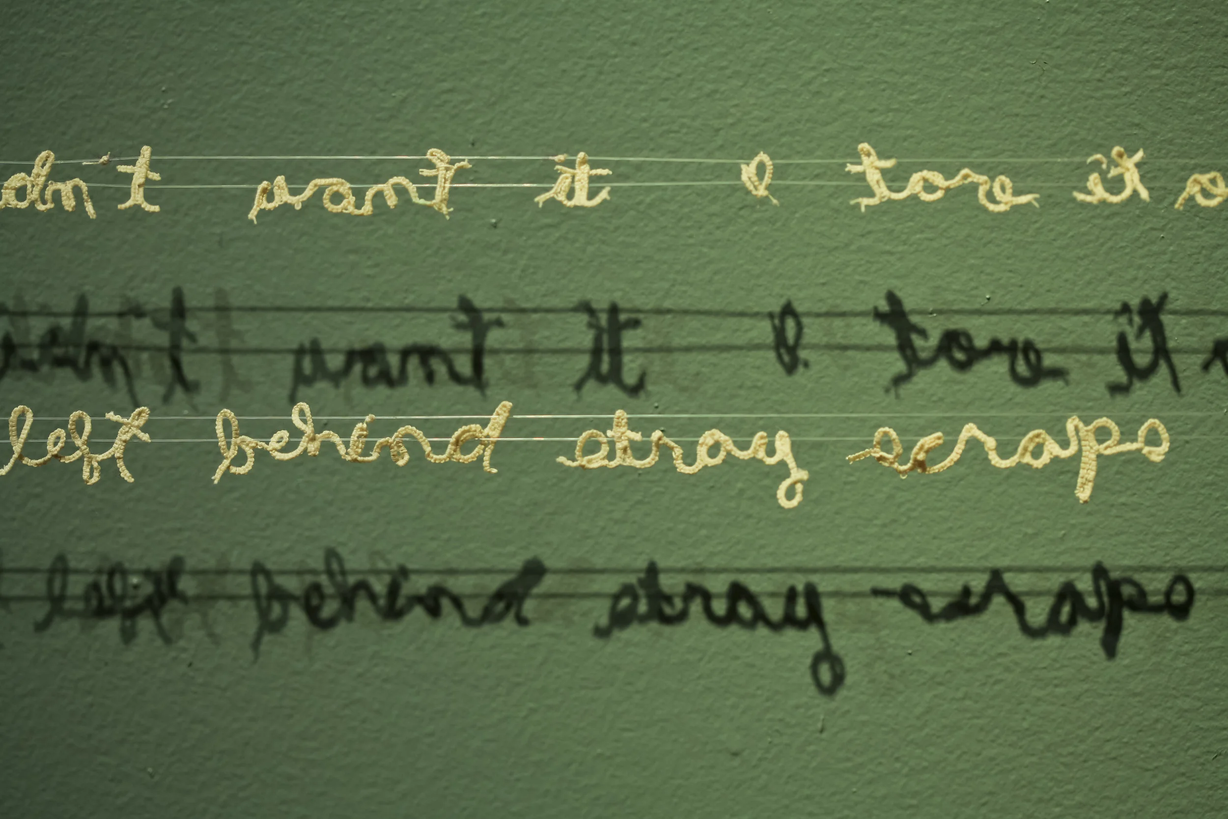 Untitled cotton thread, nylon thread 2012 text reads, "I had a spot on the hoizon between two scrappy clumps of trees | I didn't want it. I tore it out. It left behind stray scraps in the coil binding."