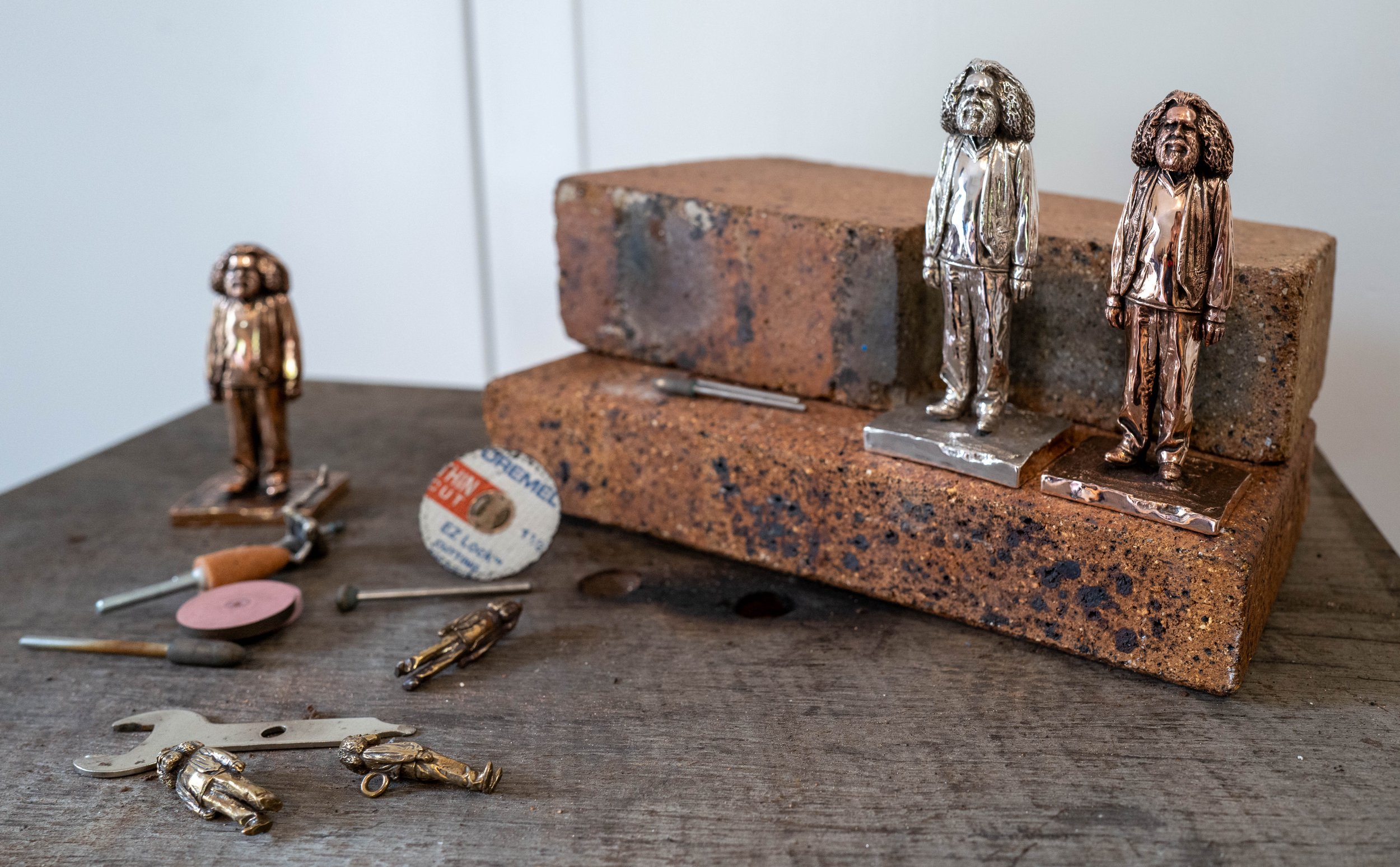 Standing: Red bronze and solid silver, 11cm.  Below: traditional bronze, 1cm.