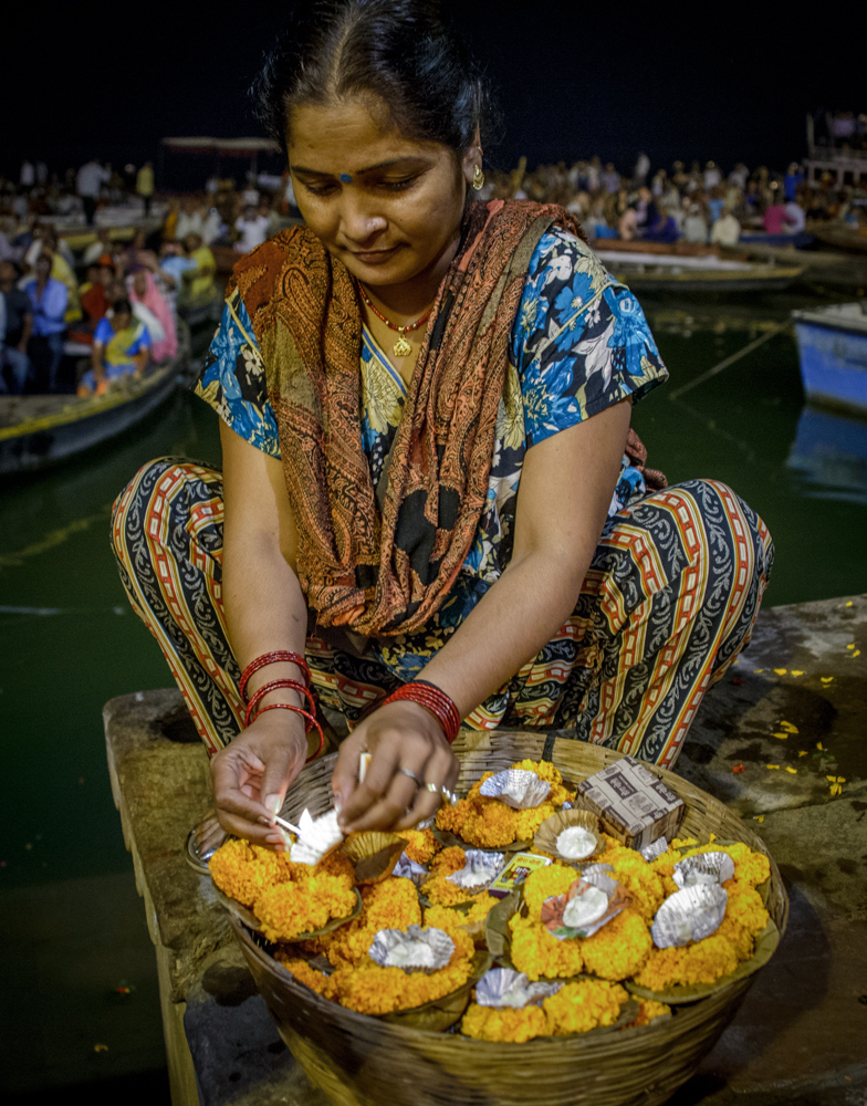 Woman selling lit candles