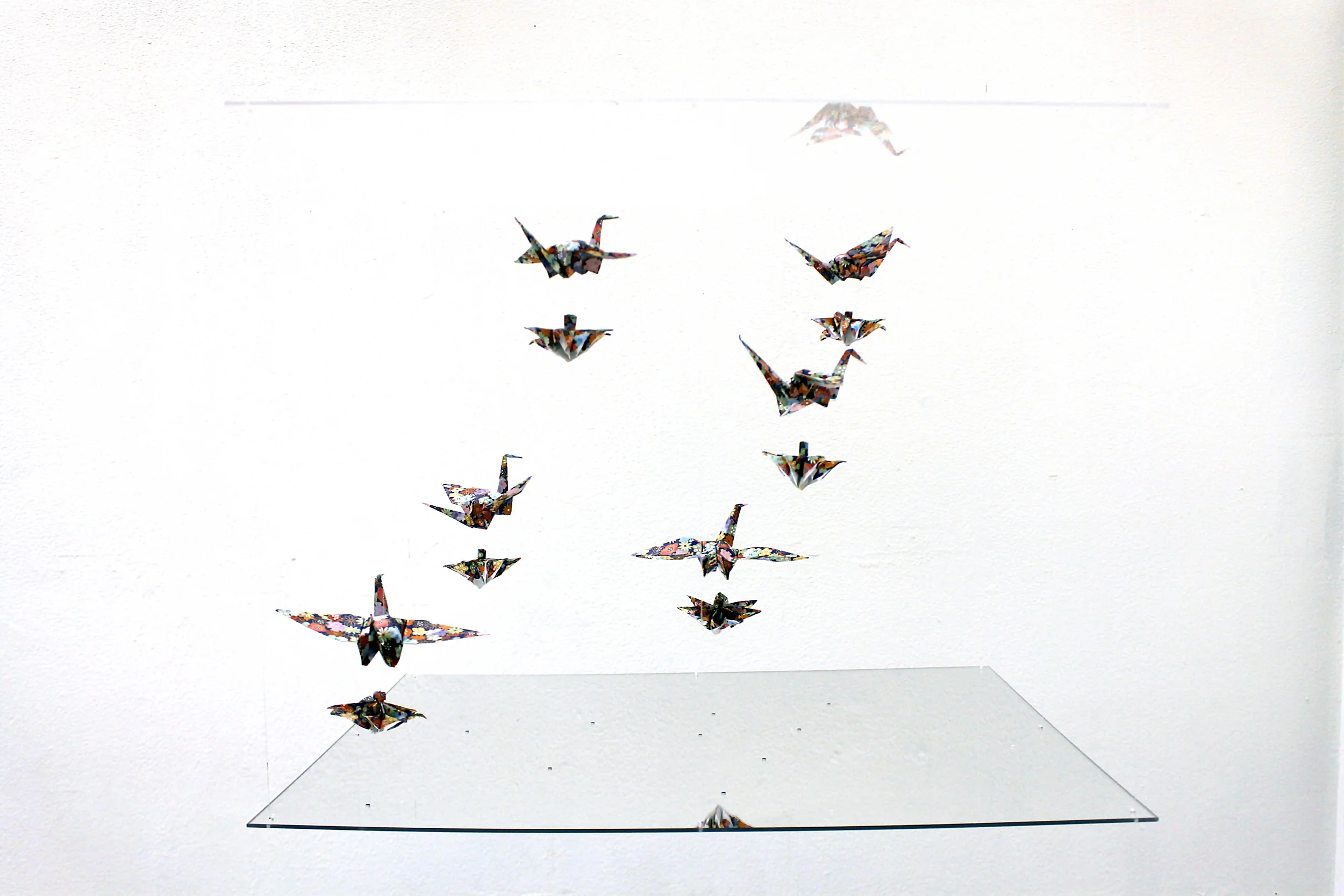 The only remaining artifact of this project is this picture. The fragile balance between the super-magnets can be easily disturbed, causing the birds and flowers to clump together with the slightest movement. A slight breeze in the room causes the birds and flowers to dance precariously between a mirror (bottom) and an acrylic panel (top). 