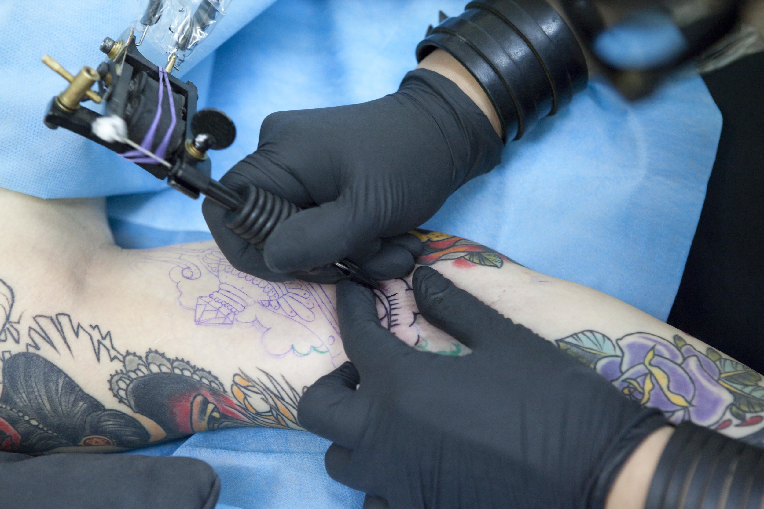  Li Yang of Beijing's New Tattoo Studio tattoos the arm of a young woman in July 2012. Once the mark of gangsters and other unsavory characters, tattoos have become widely accepted in modern urban China. Photograph for City Weekend. 