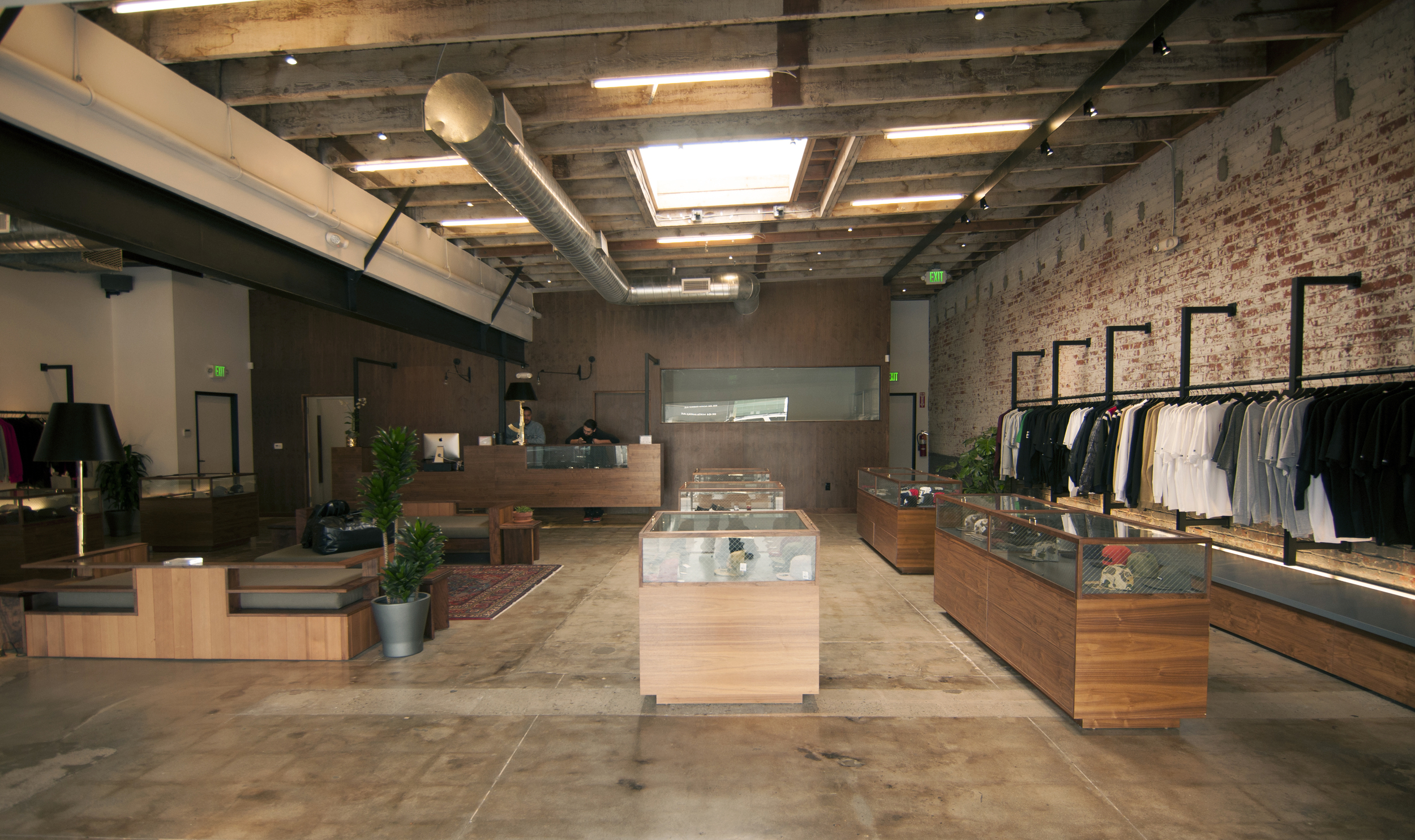 In order to create a more refined modernist aesthetic all of the materials were peeled away, exposing the original finish of the concrete flooring, showing exposed wood ceilings and the brick walls with their original paint, and juxtaposed with custom built walnut casework.
