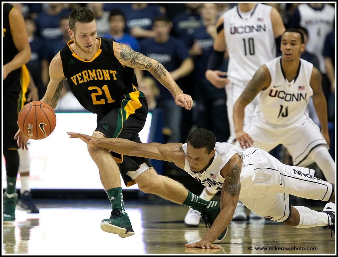 UCONN'S #21 Omar Calhoun fights for a loose ball against Vermont's # 21 Candon Rusin during second half action on Tuesday November, 13 2012. UCONN would win 67-49. 