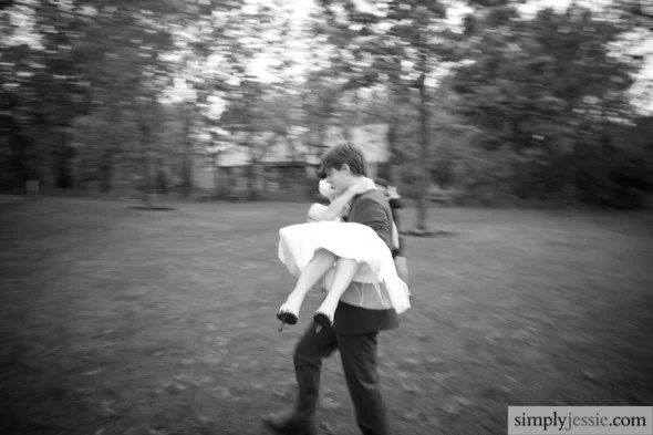 Groom carrying bride