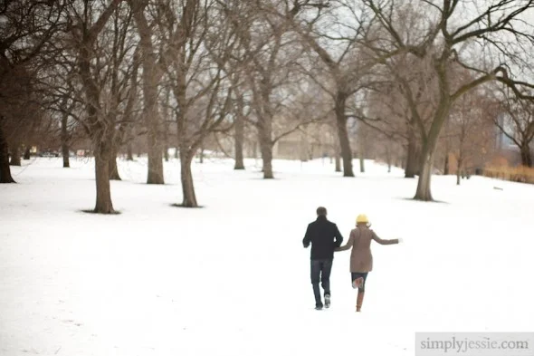Engaged Couple running through snow