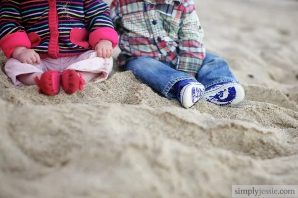 Twins feet in sand
