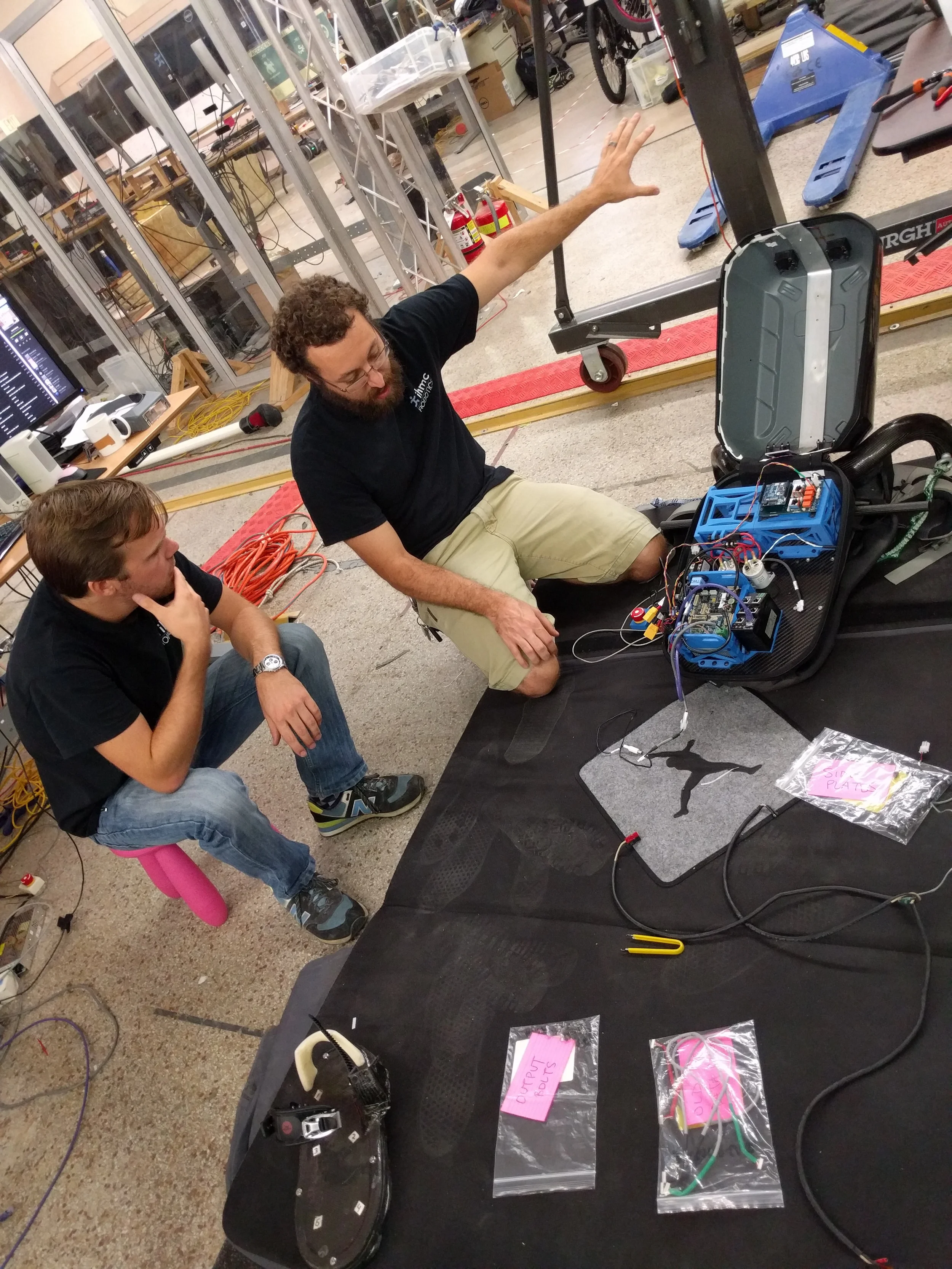 Olger (left) and Travis (right) reviewing the electronics in the backpack.