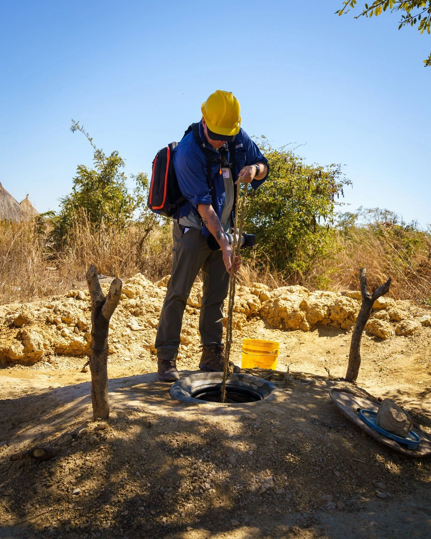 fishing for water (from a hand dug well before the clean water well was finished - no, I didn't drink from it!) . Chibombo, Zambia , Africa