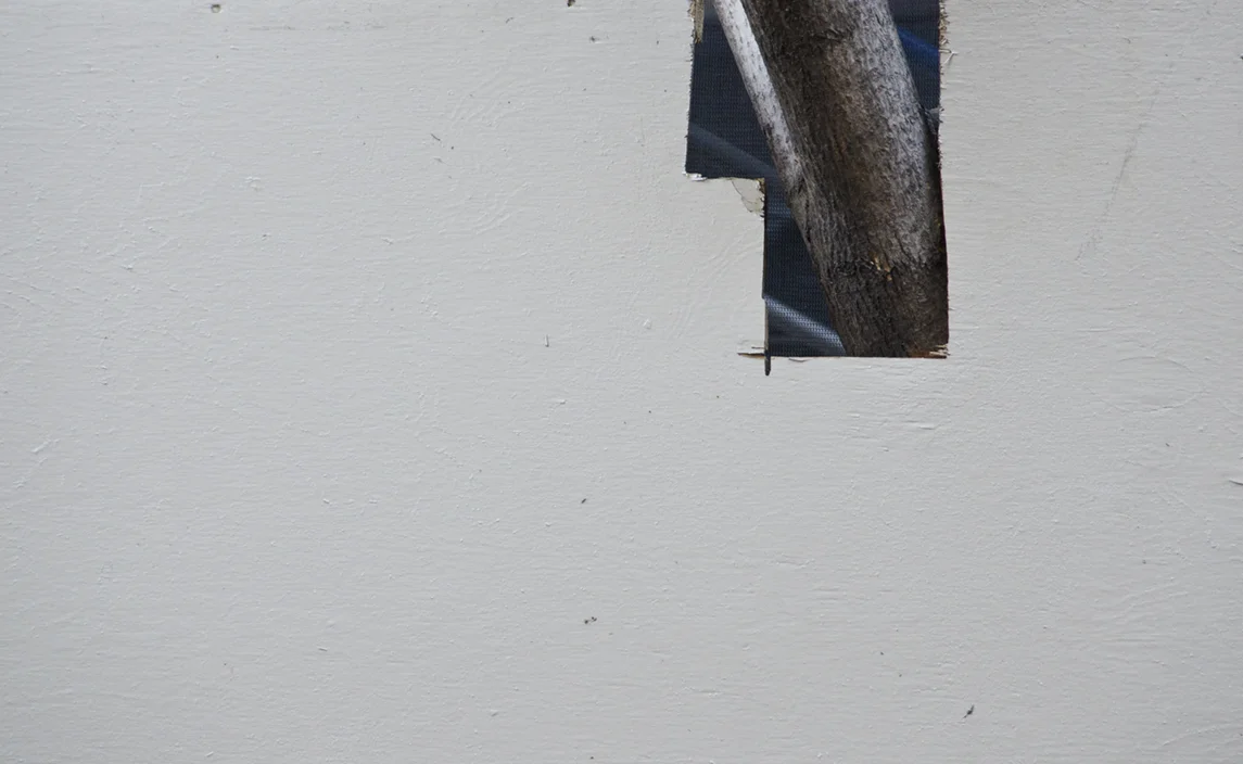 The frowning face looks left. Painterly scaffold and cutout forms are the "found art" of the city. In winter, the trees are as grey as an elephant’s skin. Brooklyn 2013.
