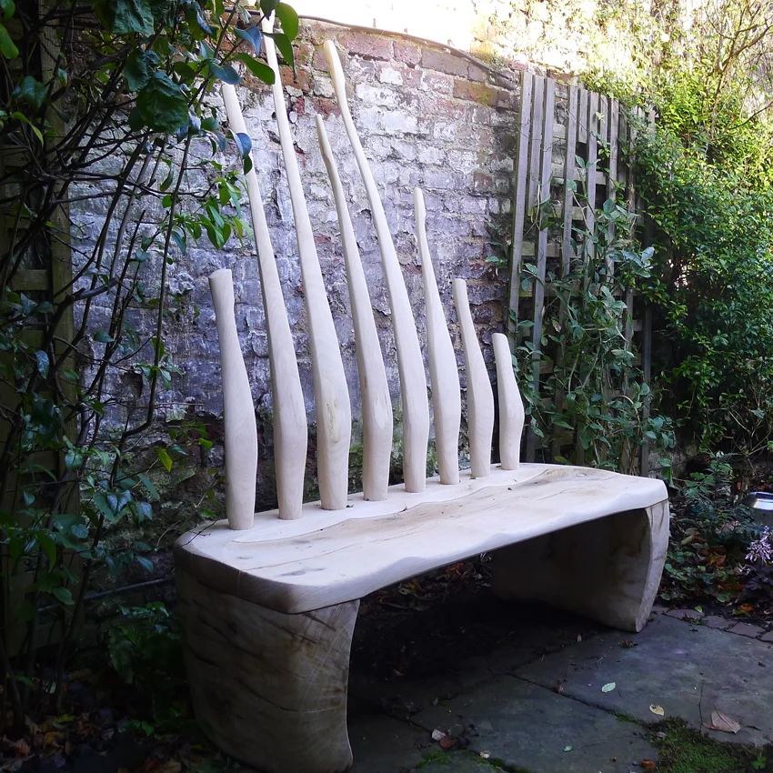 Twill - Small sculptural bench with good comfort provided by the ergonomic styling in the fluid organic back rest forms.