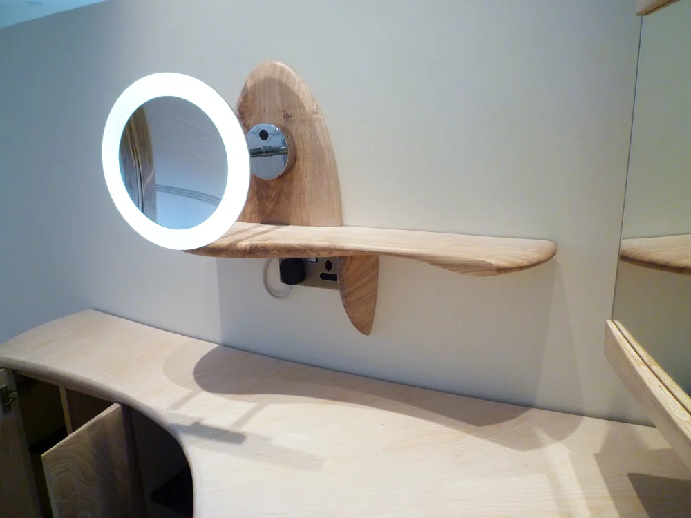Vanity area - detail showing small shelf and magnifying light