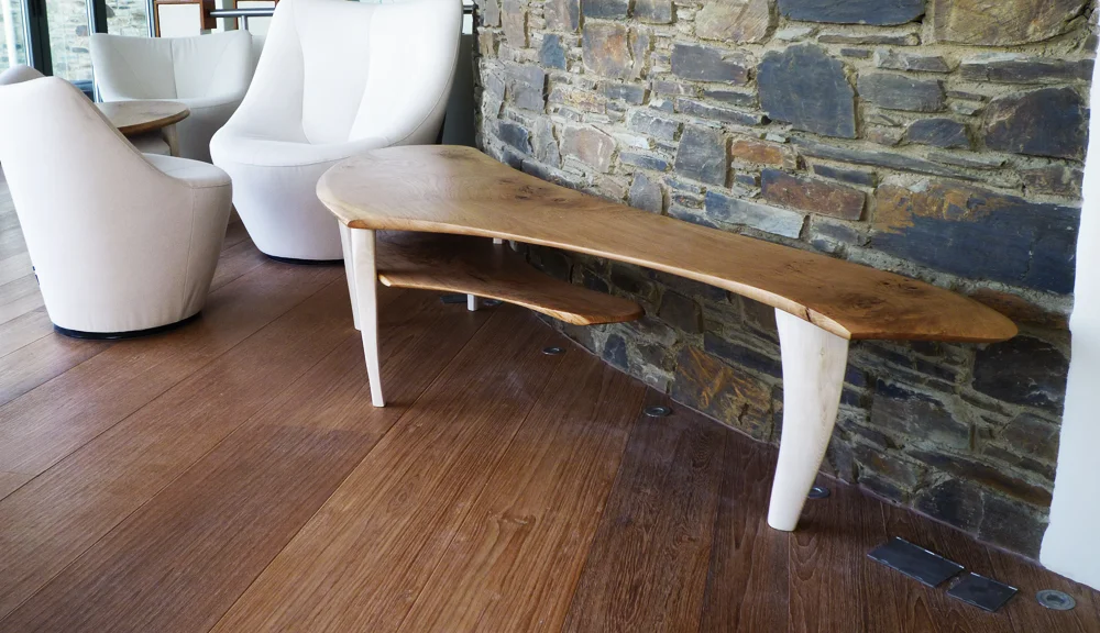 Site specific sculptural table design fitted to convex curved wall