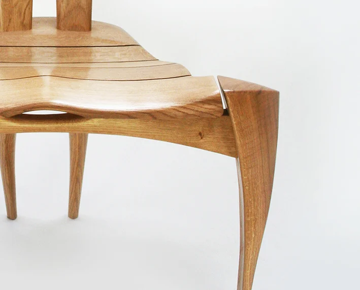 Hammerhead sculptural chair carved in oak - detail showing mouth parts and fluid line work of front legs.