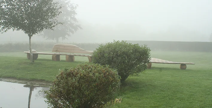 The 8.5 m long Sleeping Dragon bench lying in the mist.