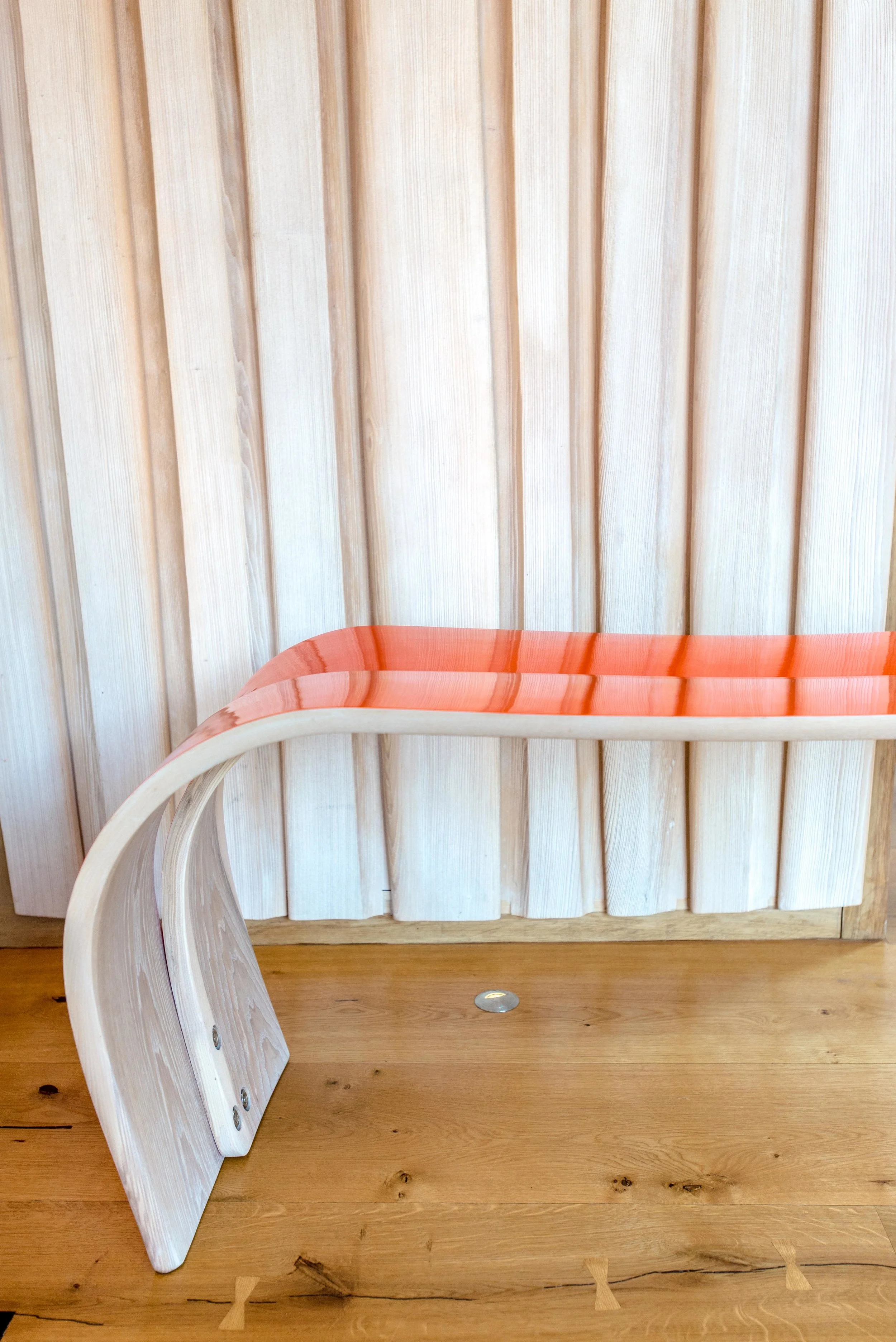 ChairCreative_Damian_OrangeBenchAgainstWoodPanelHalfCLR_LowRes.jpg