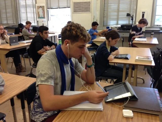 An AP French Student listens to French news on an iPad.