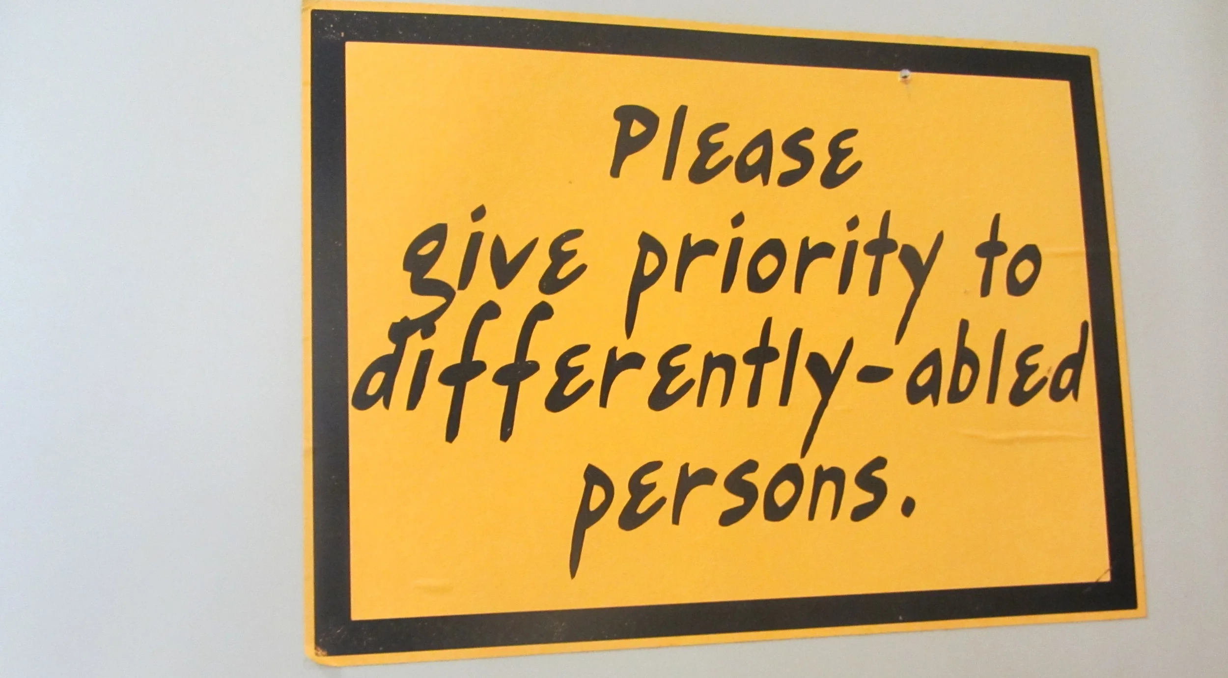 Manners are important as this restroom sign asks: "Please give priority for differently-abled persons" (Photo by Lisa Suguitan Melnick)