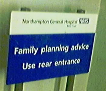 Sign displays: "Northampton General Hospital. Family planning advice. Use rear entrance."