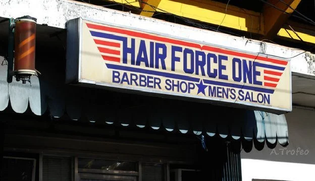 Sign displays: "Hair Force One Barber Shop Men's Salon"