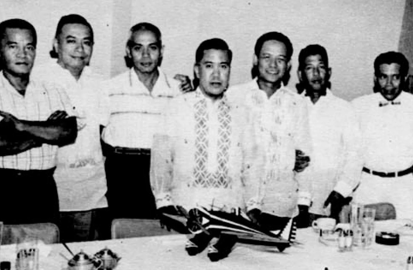 Former pilots of the Sixth Pursuit Squadron with a model of the P-26 plane they flew during World War II.