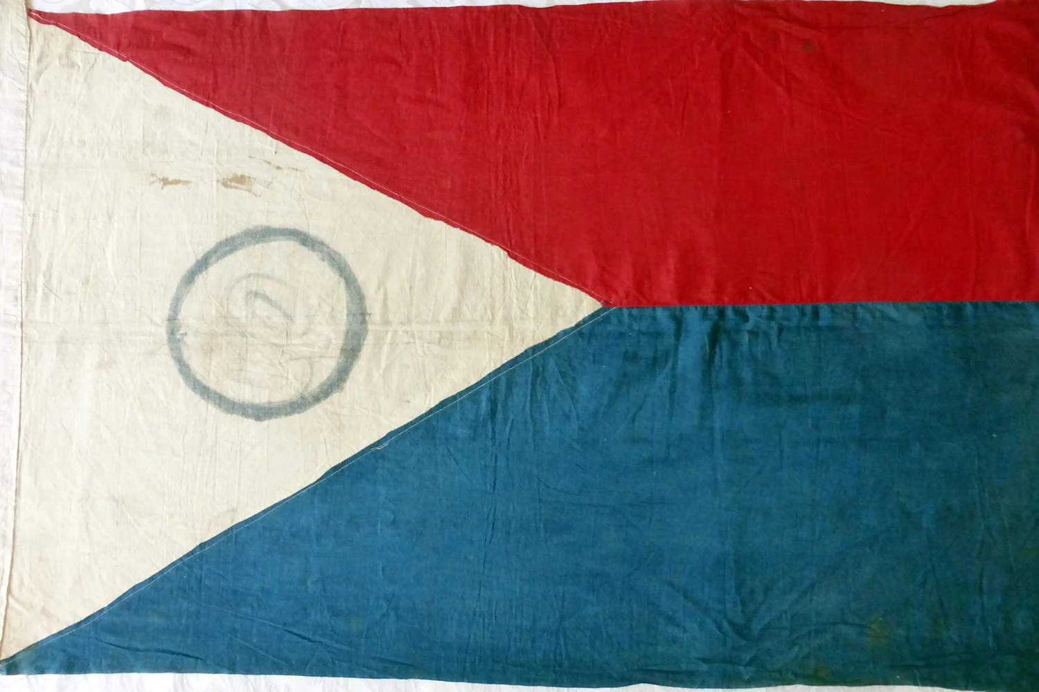 The full flag right side up with the red on top, symbolizing war. The author and his relatives are still trying to decipher what the symbol in the middle means. (Photo by I. Ver)