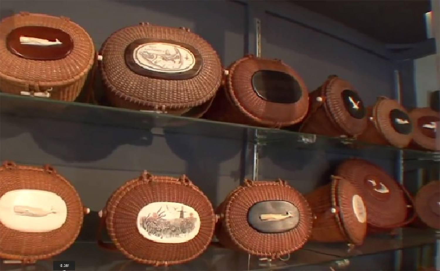 A selection of authentic and “in-the-style-of-Jose Reyes” baskets at a Nantucket Antiques store. The look is not patented, but Reyes and other basket makers sign or apply labels on their creations. (Photo is a YouTube screen grab from Sylvia Antiques website)