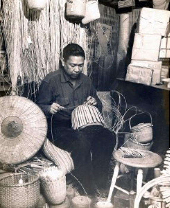 Jose F. Reyes at work in his basket studio in Nantucket, circa 1970. Note the salakot on the left side. The studio was donated to the Nantucket Historical Association. (Photo courtesy of the Nantucket Historical Association)