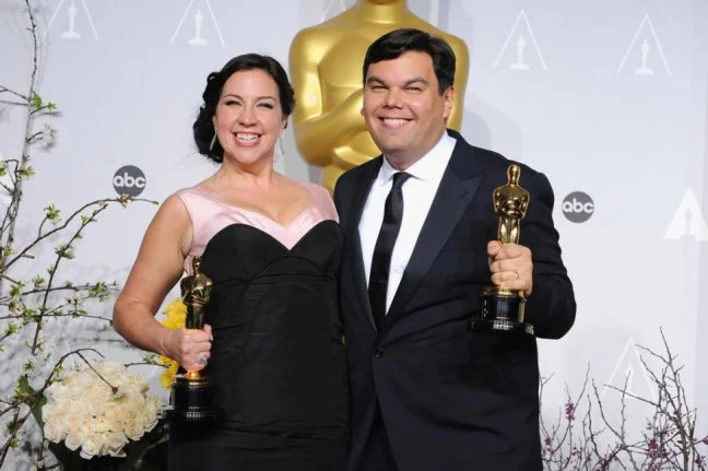 Robert Lopez (R) with wife and writing partner, Kristen Anderson-Lopez after winning the Oscar for “Let it Go” from “Frozen.” (Photo credit: Steve Granitz/WireImage)