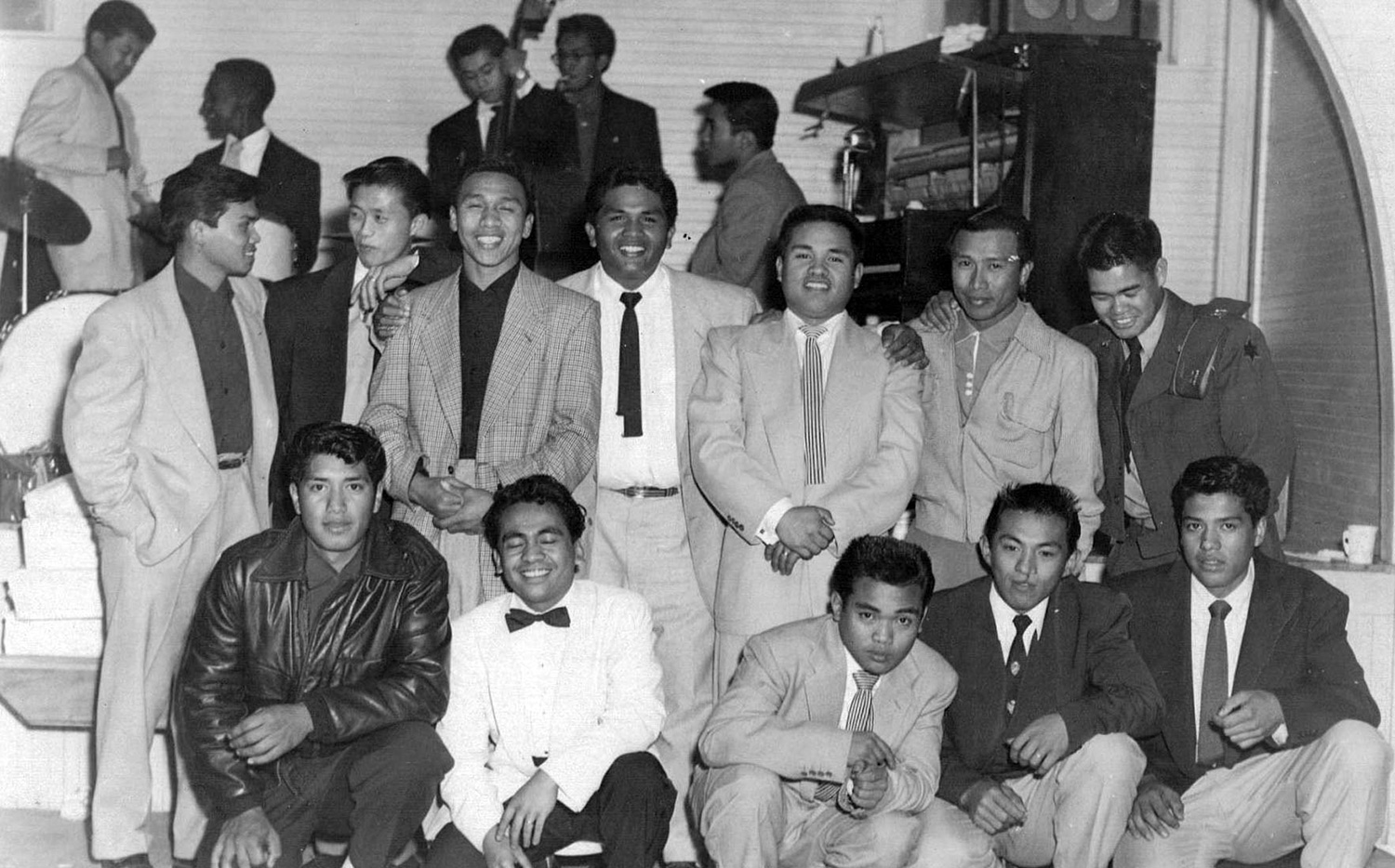 Bridge Generation young men posing at a wedding reception in Livingston in 1954. &nbsp;Note the band members on break in the background, also BG contemporaries, who provided swing/jazz music for dancing. (Photo courtesy of Peter Jamero)