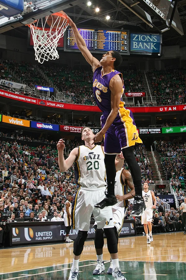 Lakers' rookie point guard Jordan Clarkson dunks over Utah Jazz forward Gordon Hayward (Source: NBA Photos/Los Angeles Lakers)